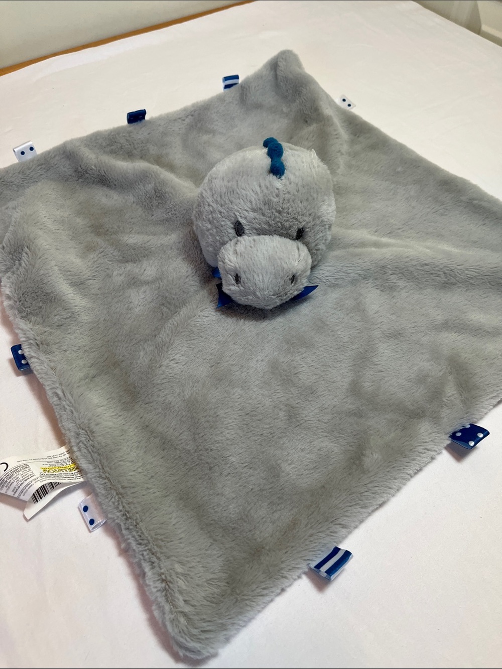 Plush grey dinosaur lovey, security blanket with tabs